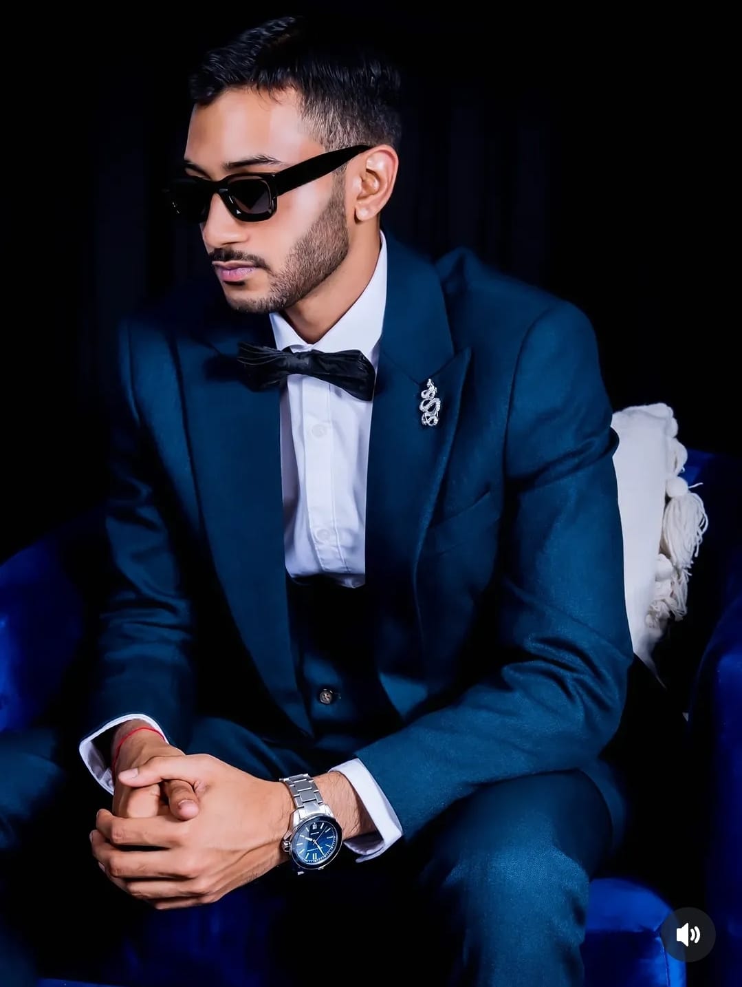 Formal studio portrait in a navy suit